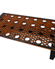 The Ao - Coral Frag Rack - Dovetail Linkable - PETG is a sleek stand with a black and orange rectangular design, featuring a perforated circular hole pattern and dovetail link. Elevated on four legs, it creates an ideal angle for seamless daisy chaining.
