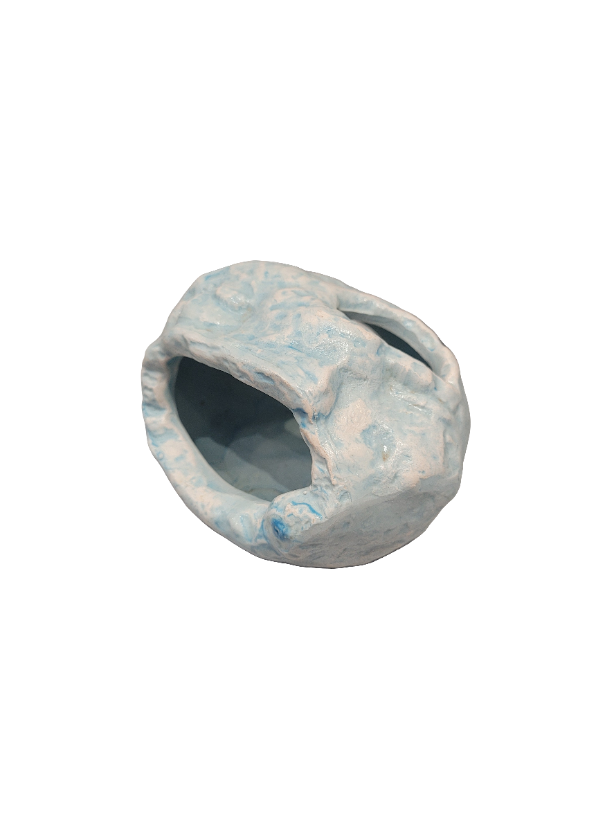 A small ceramic sculpture with an open cavity, marbled in light blue and white, named Blue Stone Hide Decor, measuring 3.5 inches wide.