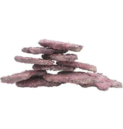 The Caribsea Purple Ledge Reef Rock is a single piece of flat, irregularly shaped purple stone that is arranged in a balanced formation. Its rough texture and varying sizes create a layered look against a plain white background.
