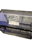 A small Aquarium Masters glass aquarium with a black frame and plastic lid seen from above features clear panel dividers. The white background emphasizes the reflective surfaces of this Deep Blue Professional Betta Aquarium.