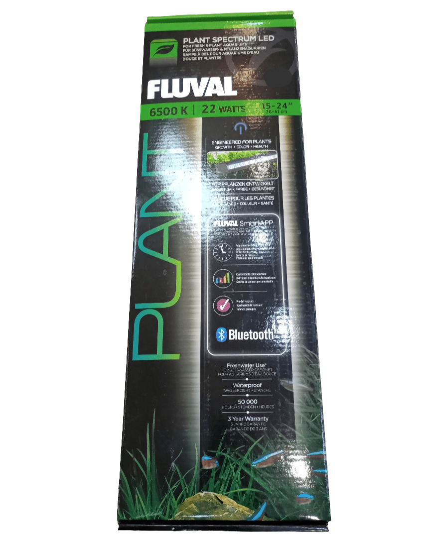 A box of Fluval Plant Spectrum LED 22 Watts 15-24 In showcases text and images emphasizing features such as a 6500K light and Bluetooth connectivity. The packaging is adorned in green and black, featuring aquatic plant designs at the bottom.