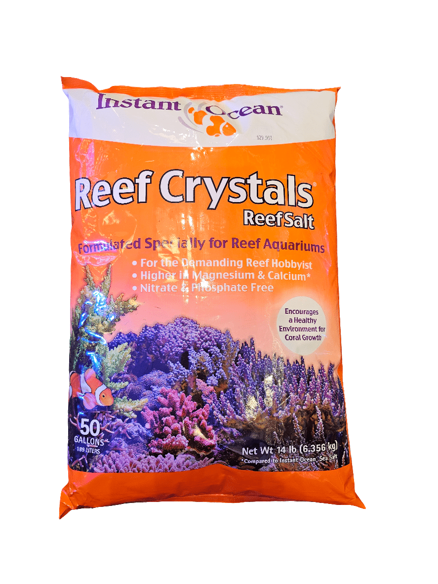 The Instant Ocean - Reef Crystals Reef Salt 50 Gal dry mix, featuring bright orange packaging with purple coral images, is ideal for reef aquariums. It is nitrate and phosphate-free, enriched with magnesium and calcium to promote optimal coral growth. Net weight: 14 lbs (6.35 kg).