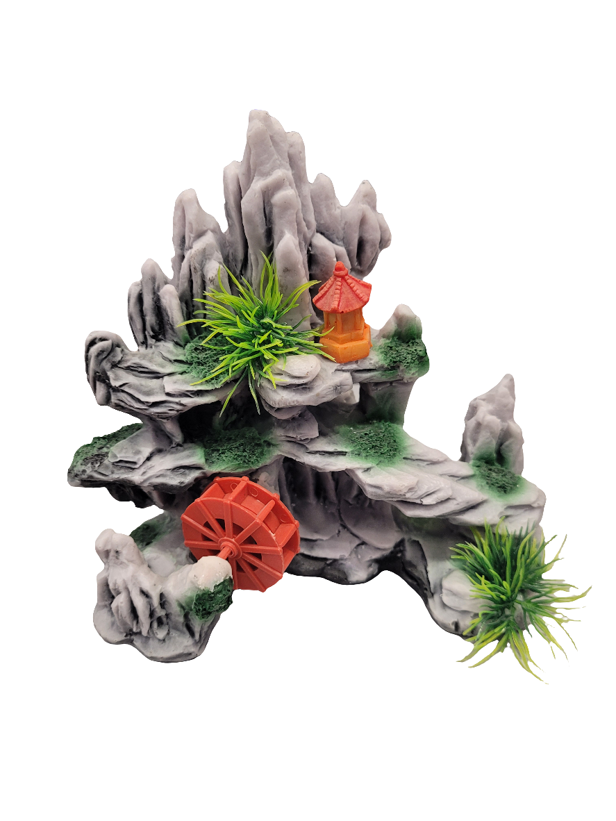 The Slate Rocky Decor, a 6-inch sculpture, features small green plants, a red pagoda, and a spinning red waterwheel. It creates a miniature landscape scene resembling rocky terrain with natural and architectural elements.