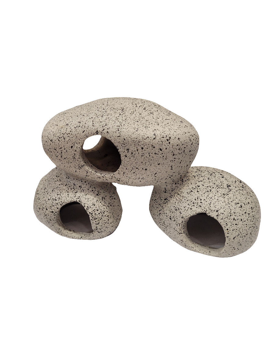 The Three Rock Swimthrough Decor features three stacked hollow stones with speckled gray surfaces and circular openings, creating a sculptural look perfect for aquarium decorations.