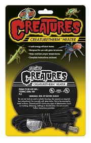 Packaging for a Zoo Med - Creatures CreatureTherm Heater U.T.H. showcases vibrant insect imagery and a coiled black cord on the front. The product assures energy-efficient heating for terrariums while cautioning about the risk of electric shock.
