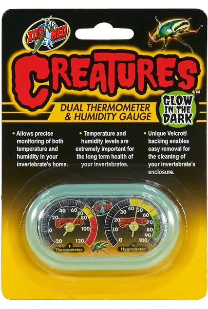 The Zoo Med Glow In The Dark Creatures Dual Thermometer/Humidity Gauge, designed for invertebrate enclosures, features a glow-in-the-dark design with thermometer and hygrometer images for precise monitoring.