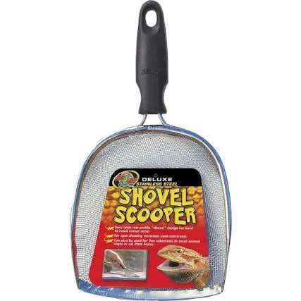 The Zoo Med - Deluxe Shovel Scooper features a stainless steel shovel scooper with a black handle and metal mesh scoop. Packaging includes a lizard and text on cleaning various substrates.