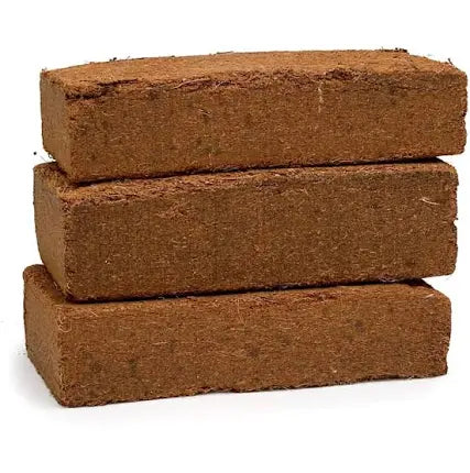 Three stacked Zoo Med Eco Earth bricks on a plain white background.