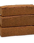 Three stacked Zoo Med Eco Earth bricks on a plain white background.