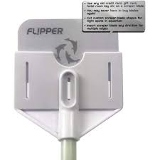 Close-up of the Flipper - Platinum Aquarium Scraper 18, featuring a rectangular design with a handle attachment. The label suggests creative uses for old credit cards, like making custom edging tools. A small instructional text is visible at the top right.