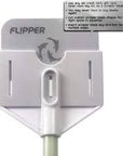 Close-up of the Flipper - Platinum Aquarium Scraper 18, featuring a rectangular design with a handle attachment. The label suggests creative uses for old credit cards, like making custom edging tools. A small instructional text is visible at the top right.