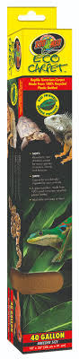 The ZooMed Eco-carpet 40 Breeder, measuring 18" x 36" and available in a tan color, comes in tall, rectangular packaging designed for terrariums. The package features images of reptiles and product details, emphasizing its eco-friendly construction from recycled plastic. It highlights suitability for 40-gallon habitats with the brand logo prominently displayed at the top.