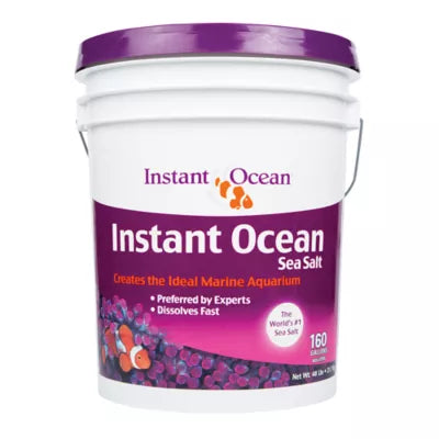 A white bucket of Instant Ocean Sea Salt features a purple label, highlighting its use for perfect marine aquariums, fast dissolving properties, and expert preference. It displays clownfish images and states The Worlds #1 Sea Salt. Product: Instant Ocean - Sea Salt - 160 Gallon Mix - Bucket.
