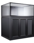 The Innovative Marine - INT 150 Lagoon Aquarium w/ APS Stand features a large black tank with a glass top section and solid base, incorporating a sleek trapezoid Infinity Overflow system hidden behind three paneled doors for a seamless look.