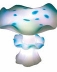 The Tetra Wonderland Collection RGB Mushroom lamp boasts a whimsical design with a white and blue cap and stem, adorned with enchanting blue spots, providing a fairy-tale aesthetic. Featuring ColorFusion LEDs, it emits a gentle ambient light.