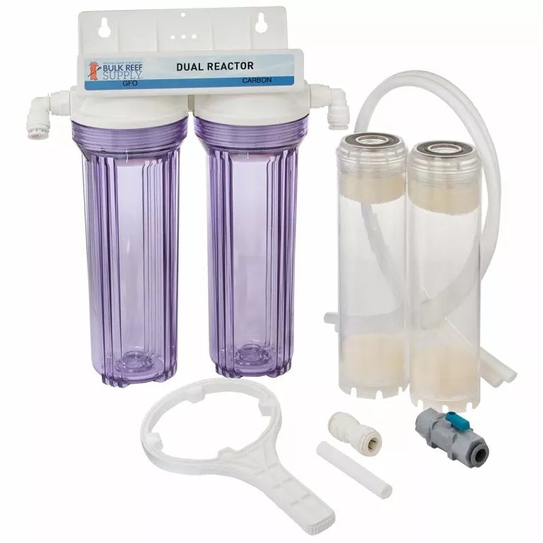 The Bulk Reef Supply BRS GFO & Carbon Reactor - Dual features dual transparent canisters labeled Carbon and includes various parts like tubes, fittings, and a wrench for water purification or aquarium maintenance.