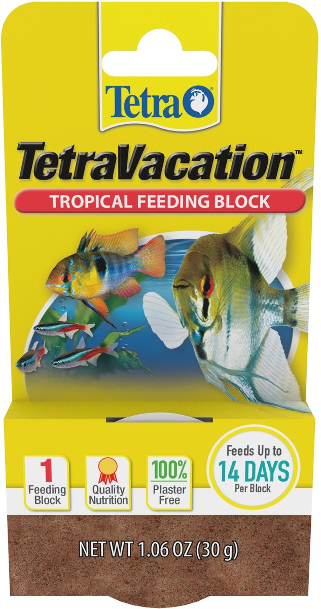 The Tetra - TetraVacation Tropical Feeding Blocks come in yellow packaging with aquarium fish images. Features include Feeds Up to 14 Days Per Block, Quality Nutrition, and 100% Plaster Free. The packaging includes the Tetra logo and a net weight of 1.06 oz (30g).