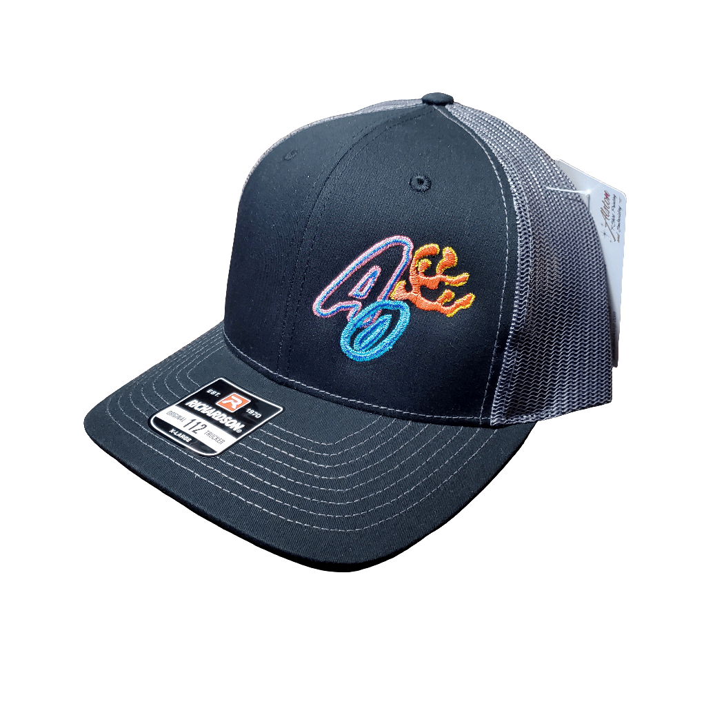 A black and gray mesh baseball cap from AO Hats, featuring a vibrant embroidered design on the front. The cap includes a tag on the brim with brand details and barcodes.