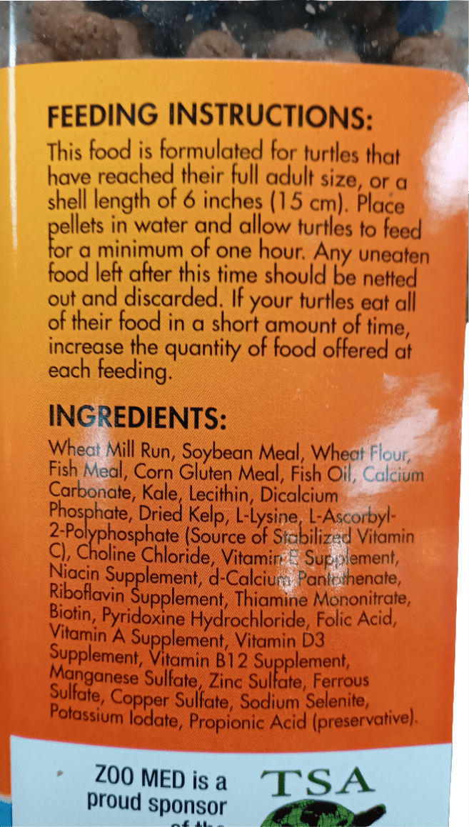 The label on the Aquatic Turtle Food Zoo Med 12oz container displays feeding instructions, a list of ingredients, and states its suitability for turtles with a shell length of at least 6 inches. The product is endorsed by Zoo Med in collaboration with TSA.