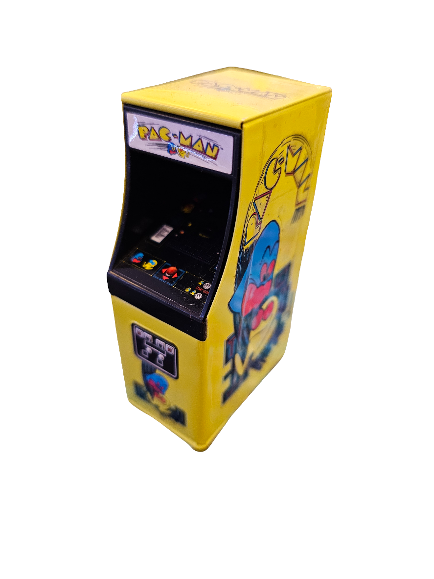 A miniature yellow arcade machine designed as the Bandai Pacman Candy Tin 17g, featuring retro Pac-Man graphics with detailed artwork, including the iconic character and maze patterns on the sides.