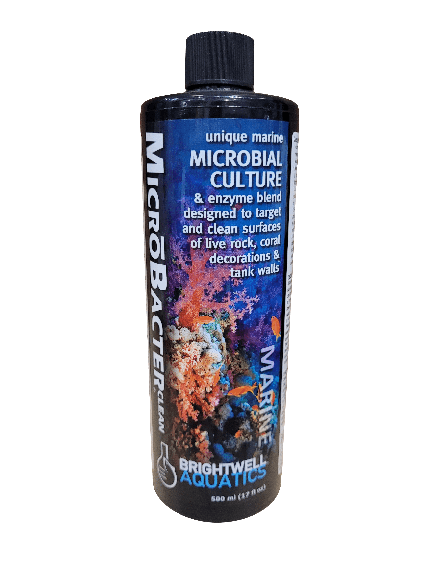 A 500ml bottle of Brightwell MicrobacterClean, a microbial culture and enzyme blend designed for cleaning live rock, coral decorations, and tank walls. The label displays vibrant coral imagery and outlines the product's purpose.