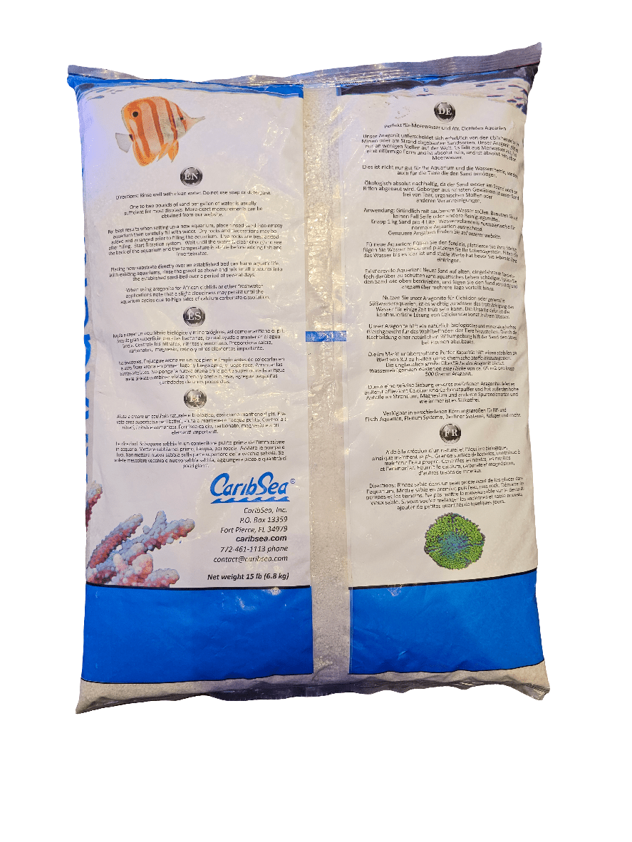 A pre-packaged bag of CaribSea - Special Grade Reef Sand - Aragonite 15 Lb featuring instructional text and product information. The design showcases images of a clownfish and coral, with the brand name CaribSea prominently displayed, alongside printed details like weight and contact information.