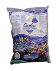 A bag of Caribsea - Arag Alive Sand - Hawaiian Black 10 lbs. The packaging features vibrant images of coral reefs and fish and claims to reduce nitrates while promoting a balanced ecosystem for marine aquariums.