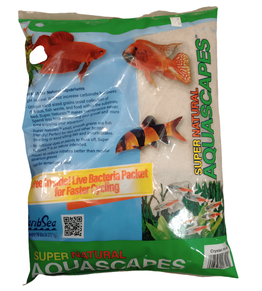 A bag of Caribsea Crystal River 20lb aquarium substrate is shown, adorned with images of tropical fish and aquatic plants, and includes text about a live bacteria packet for faster cycling. The brand name is CaribSea.