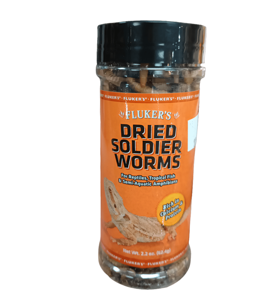 A jar labeled "Fluker's - Dried Soldier Worms 2.2 Oz" with an orange label contains dried worms designed for reptiles, tropical fish, and semi-aquatic amphibians, emphasizing their high calcium and protein content.