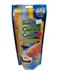 A 12 oz (342g) package of Hikari Cichlid Gold Mini Sinking fish food, in blue and gold packaging adorned with fish images and labeled as a color-enhancing diet for cichlids and tropical fish, priced at $19.99.