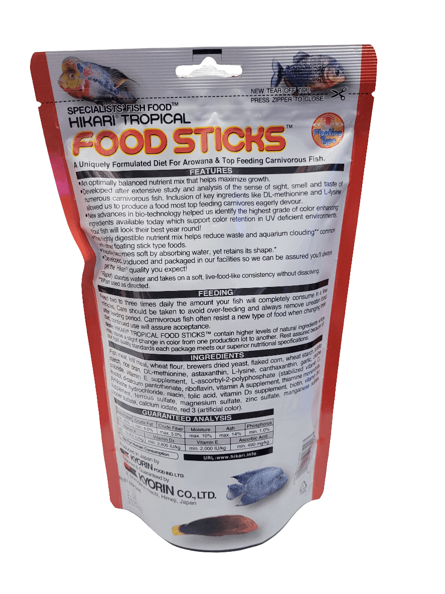 Image of a 250g package of Hikari Food Sticks (Floating). The red and white packaging features fish imagery, specifically formulated for arowana and top-feeding carnivorous fish, with feeding guidelines and nutritional details provided on the reverse side.