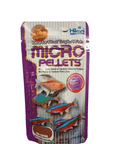 A package of Hikari Micro Pellets .77oz fish food showcases colorful images of small tropical fish, such as neon tetras, on the front. The packaging emphasizes features including a new formula, protein blend, enhanced flavor, semi-floating pellets, and a micronutrient coating.