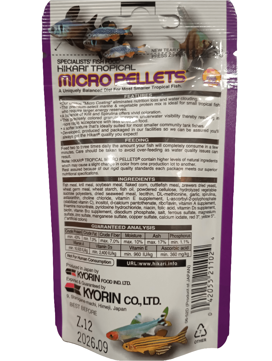 The image displays the reverse side of a Hikari Micro Pellets .77oz fish food package. The purple packaging includes a product description, feeding instructions, nutritional information, and contact details for the company.