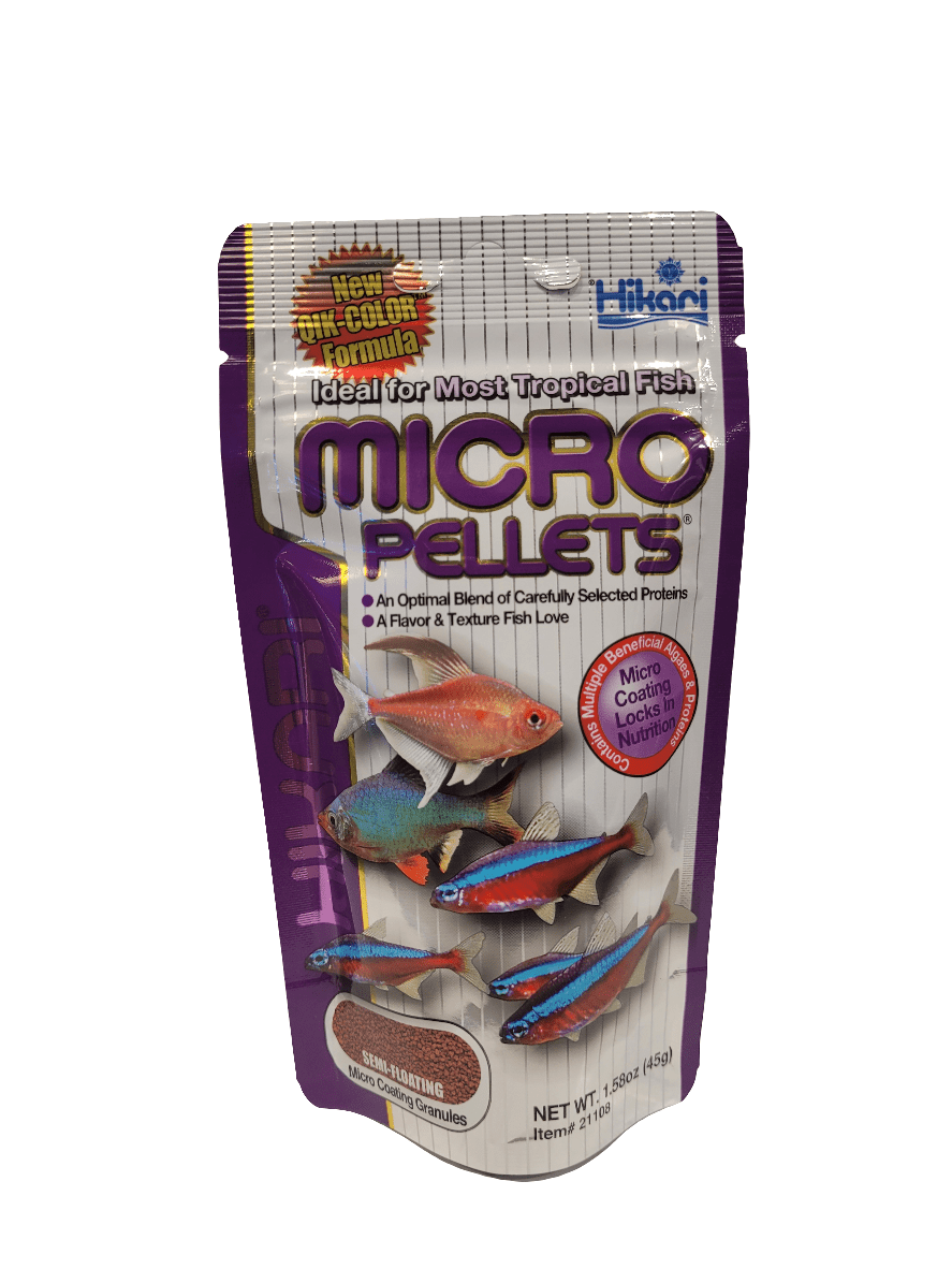 A 1.58 oz package of Hikari Micro Pellets fish food, with a purple and silver design showcasing tropical fish and emphasizing the enhanced color formula, is suitable for most tropical fish.