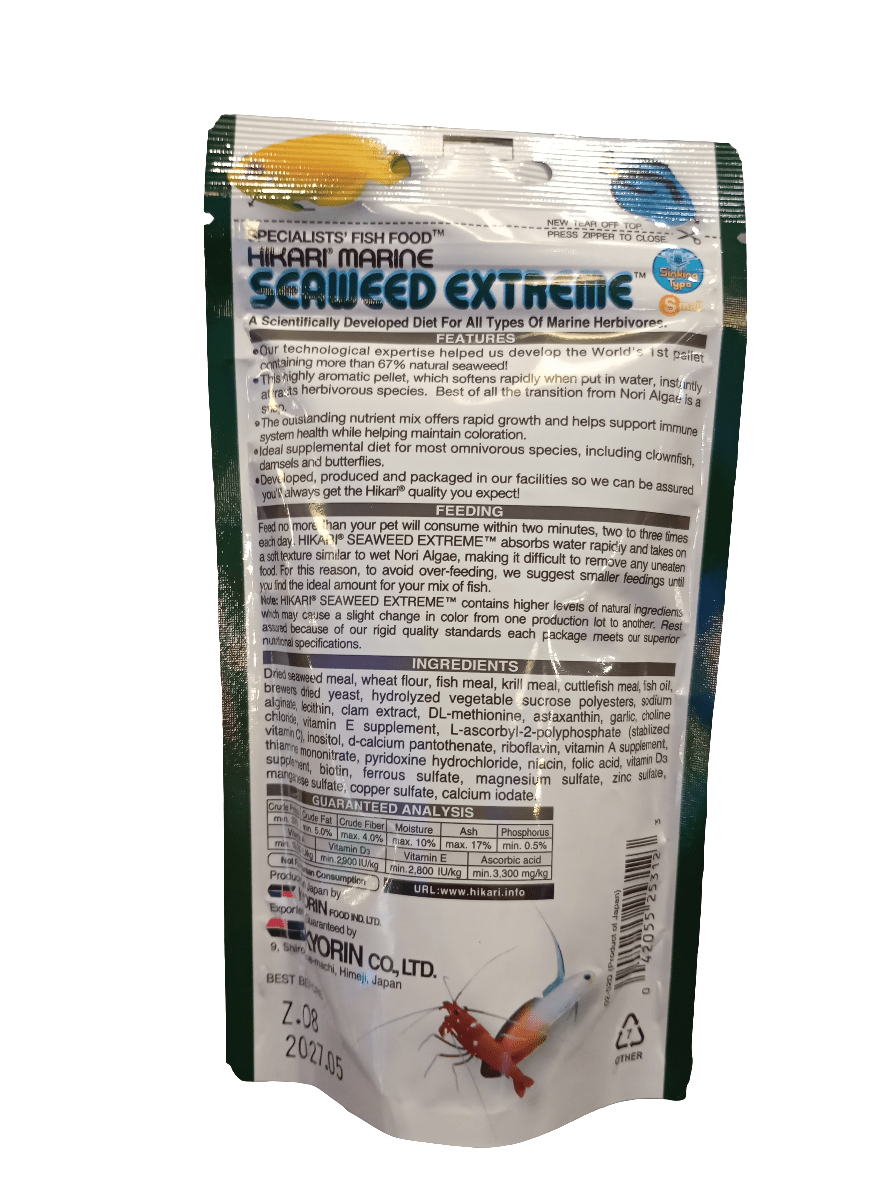 A package of Hikari Seaweed Extreme 3.52oz fish food. The packaging is white with blue and green text, displaying product details and ingredients, along with a small image of a colorful marine fish at the bottom.