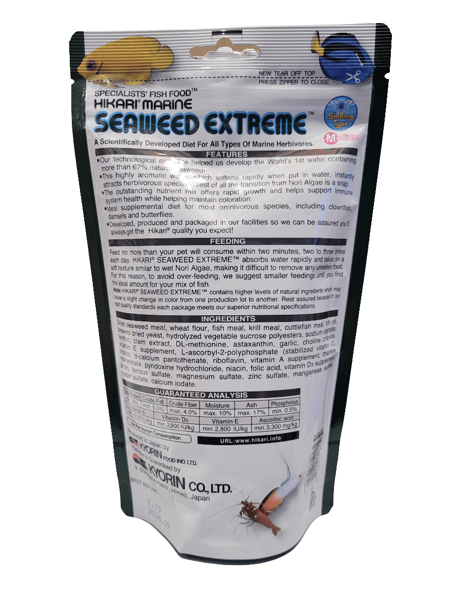 A package of Hikari - Seaweed Extreme - Med Sinking Pellet 8.8oz fish food designed for growth features detailed information on the front about its ingredients, nutritional content, and feeding instructions. It is adorned with illustrations of fish and includes a small clear window that reveals the colorful herbivore pellets inside.