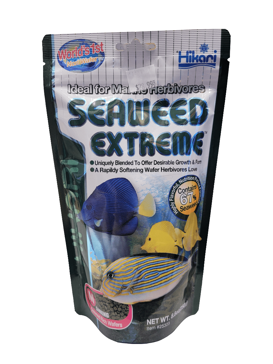 An 8.8oz package of Hikari Seaweed Extreme Med Sinking Pellet fish food, designed for marine herbivores, features colorful images of vibrant fish on the pouch. The packaging highlights key benefits such as growth-promoting ingredients, with 67% seaweed content and rapidly softening pellets.