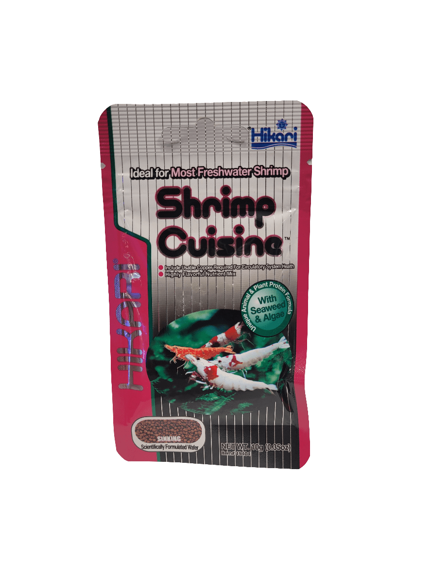 The Hikari Shrimp Cuisine Sinking .35oz pack, specifically designed for freshwater shrimp, features a red and gray packaging adorned with shrimp images. It emphasizes the addition of seaweed and algae to provide plant protein.