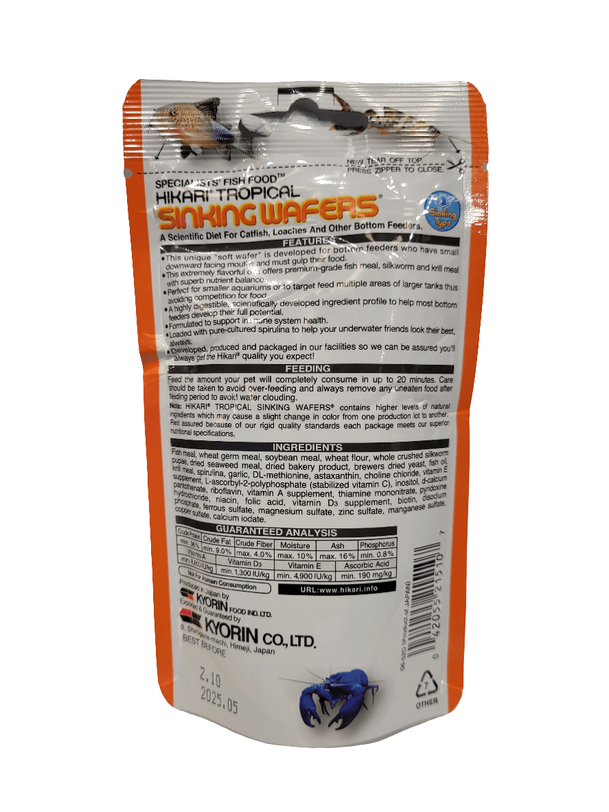 The image displays the back of a package of Hikari - Sinking Wafers - 1.76oz fish food, perfect for bottom-feeding fish. The orange packaging is adorned with black text providing detailed instructions, nutritional information, and a list of ingredients. A small blue fish graphic is located at the bottom.