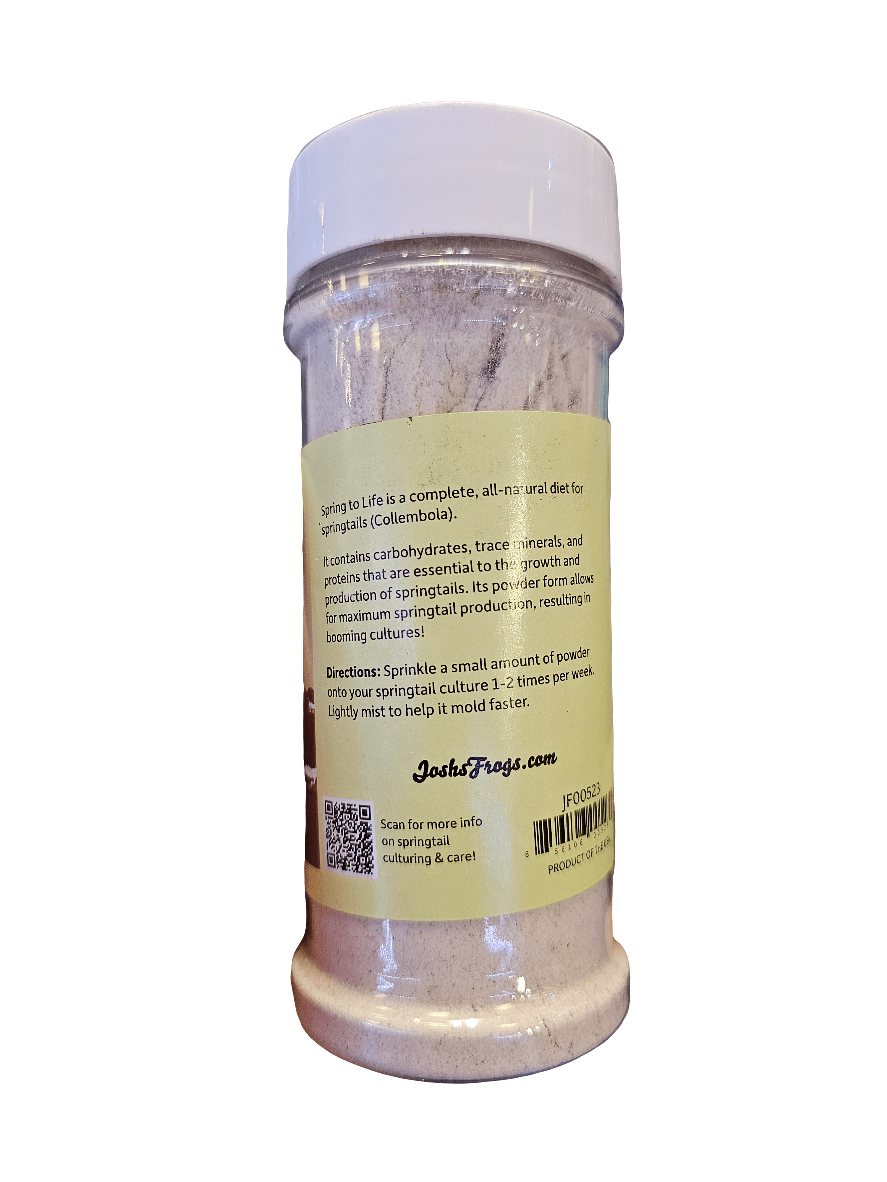 A clear plastic container with a green label titled "Joshs Frogs - Spring To Life - Springtail Food," promoting it as an all-natural diet for springtails. The label provides usage directions and outlines nutritional benefits, with a QR code located near the bottom.