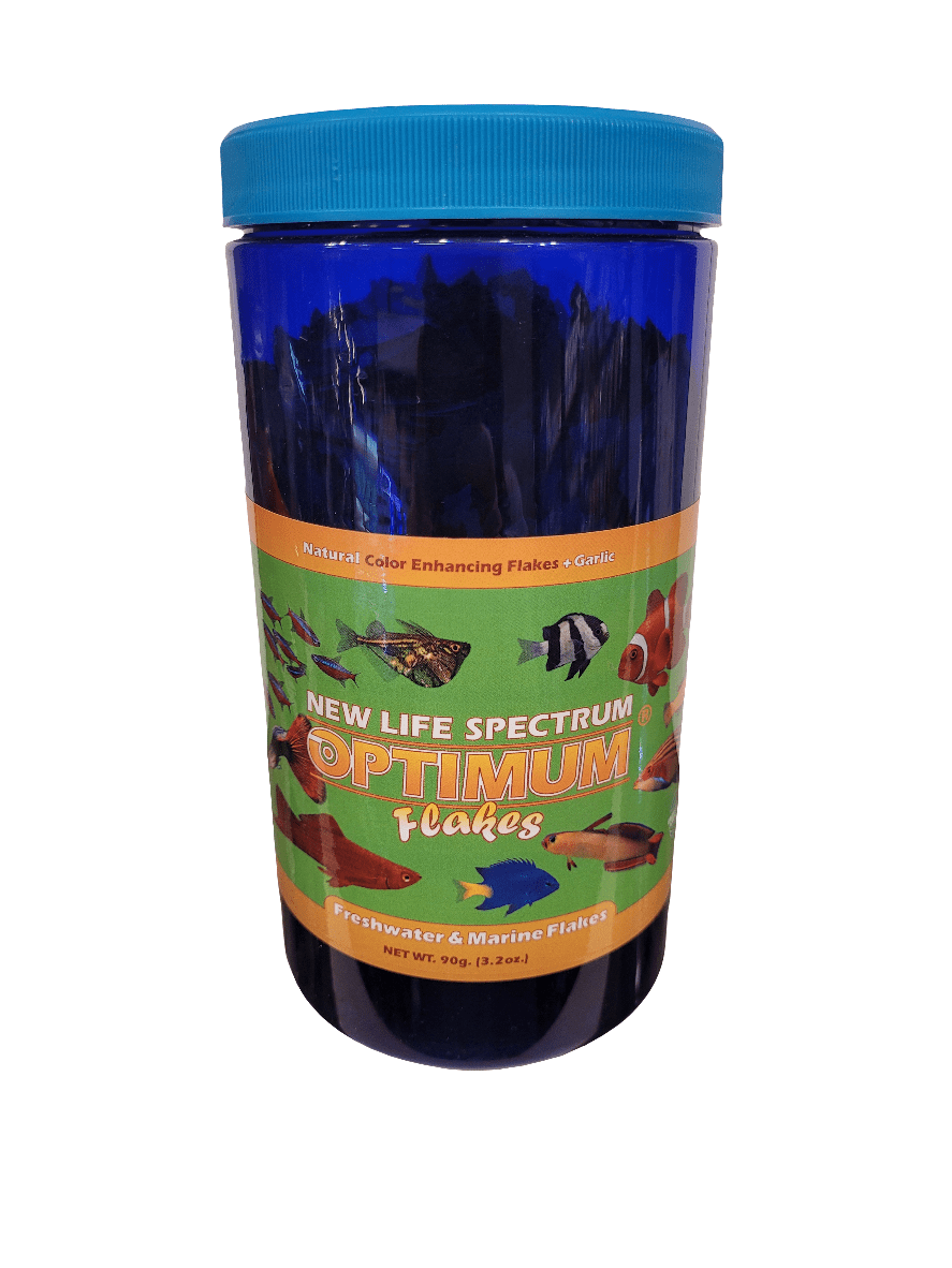 A container of New Life Spectrum - Optimum Flakes - 3.2oz fish food featuring a blue lid. The label displays images of fish and indicates it is suitable for both freshwater and marine fish, with natural color-enhancing flakes. The net weight is 90g (3.2oz).