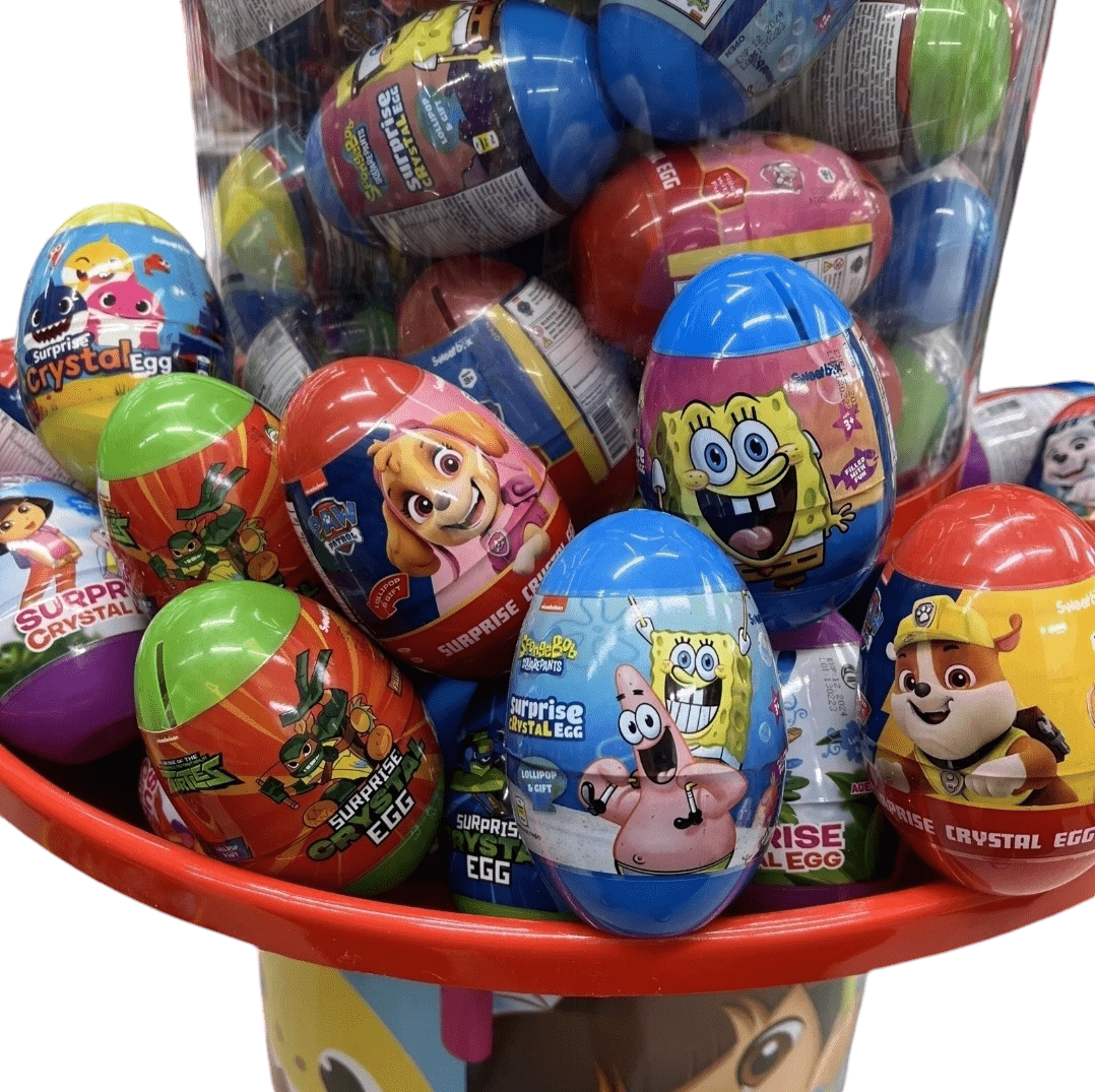 A large display bin filled with Nickelodeon Surprise Toy Eggs, showcasing characters from children's cartoons like SpongeBob and Paw Patrol. The eggs are adorned with bright, vibrant wrappers and are stacked on top of each other.