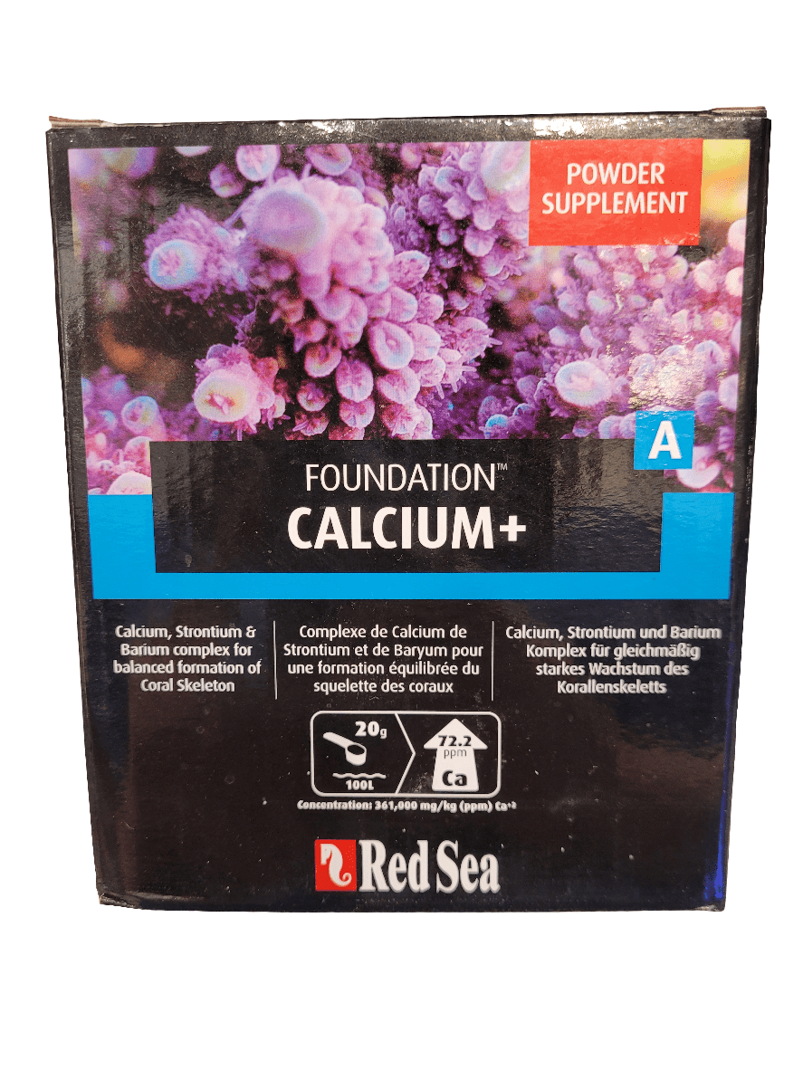 A picture of the Red Sea - Foundation Calcium+ - 1kg box, which is a powdered supplement designed to aid in coral skeleton formation, containing essential elements like calcium, strontium, and barium. The packaging is adorned with an image of purple coral.