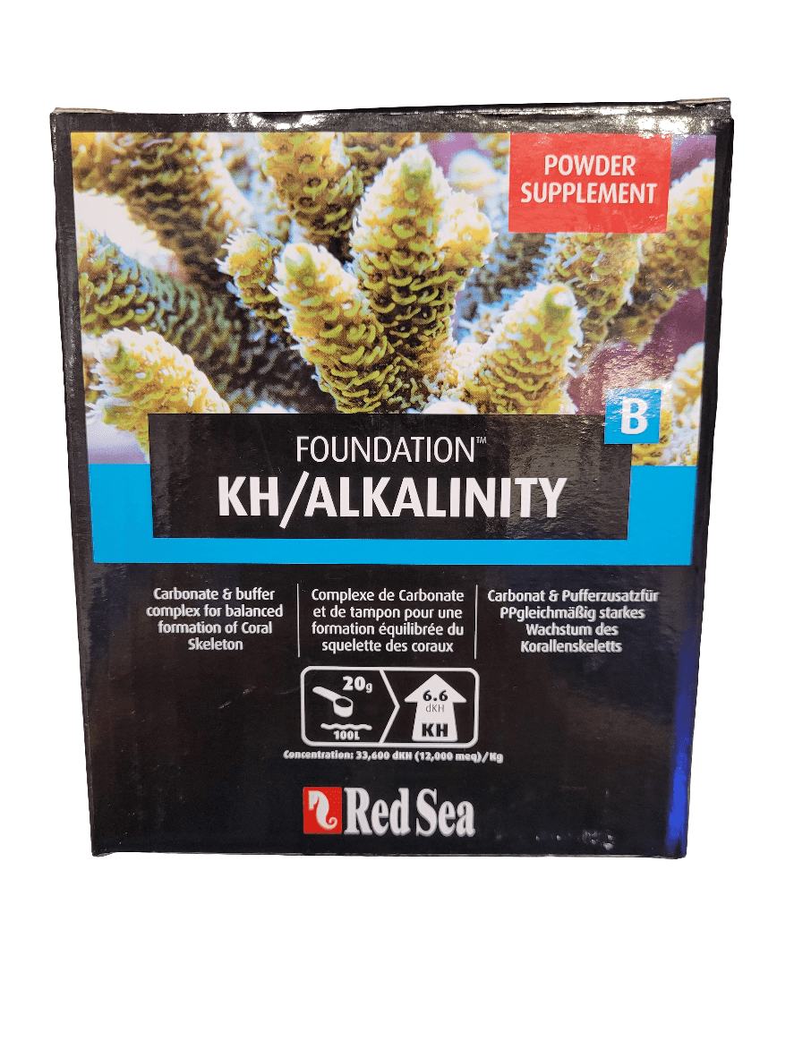 Image of a Red Sea - Foundation Kh/Alkalinity - 1kg powder supplement box showcasing carbonate and buffer complex for coral growth. The packaging is predominantly black, featuring images of coral along with product details in English and French.