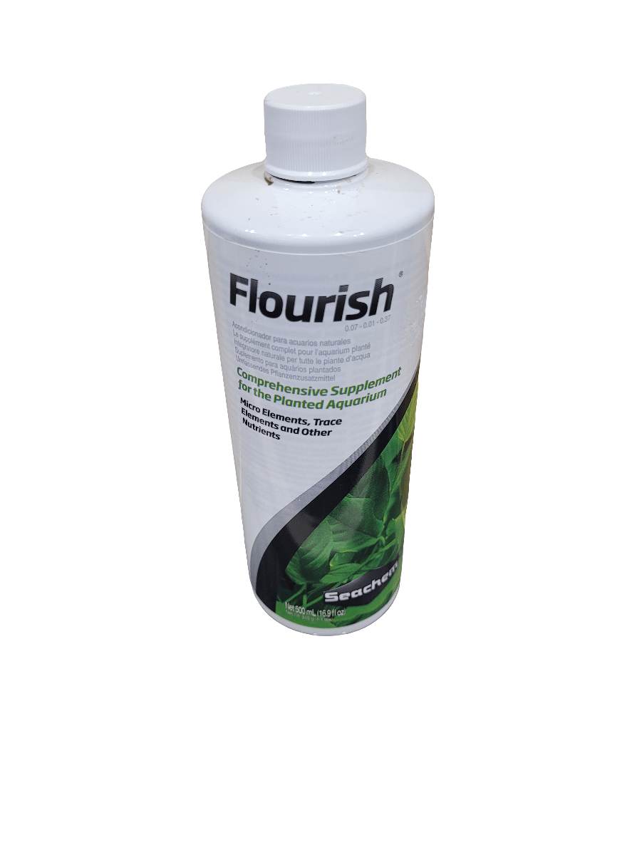 A 500ml bottle of Seachem - Flourish, designed as a comprehensive supplement for planted aquariums, featuring a white label adorned with green plant imagery and nutrient information, and topped with a white cap.