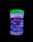 A 45g container of Tetra - GloFish Flake Food features a green lid and is decorated with images of colorful, fluorescent fish on the label, including a purple one. The text emphasizes its suitability for all tropical fish and provides nutrition to enhance their vibrant colors.