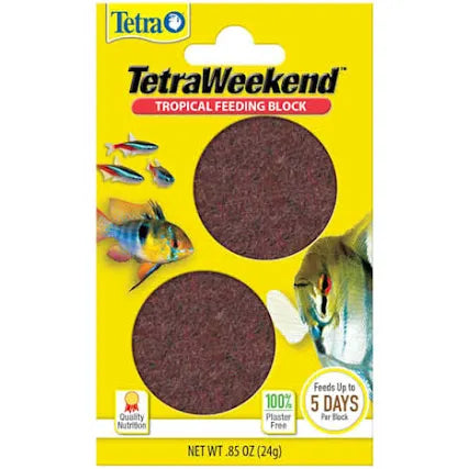 The TetraVacation Tropical Feeding Blocks come in yellow packaging with two circular blocks displayed. It is plaster-free, feeds fish for up to 5 days, includes nutrition symbols, fish illustrations, and has a net weight of 0.85 oz.