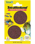 The TetraVacation Tropical Feeding Blocks come in yellow packaging with two circular blocks displayed. It is plaster-free, feeds fish for up to 5 days, includes nutrition symbols, fish illustrations, and has a net weight of 0.85 oz.