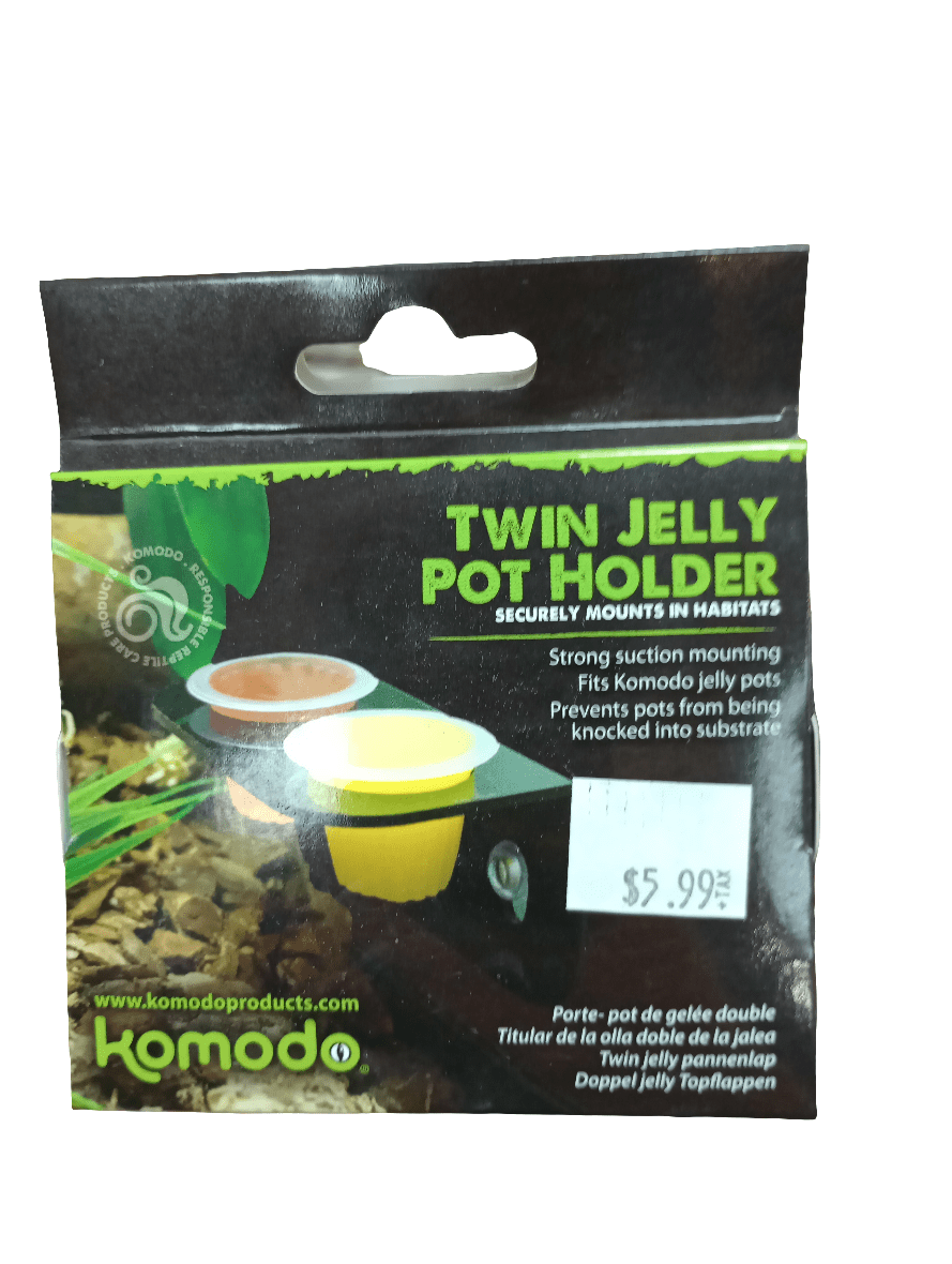 The image displays packaging for the Komodo Twin Jelly Pot Holder, a product engineered for secure attachment in habitats using powerful suction. The price on the package is marked as $5.99.