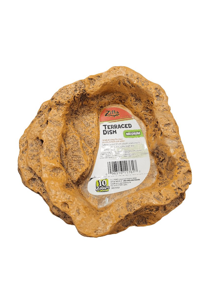 A brown, textured dish designed to look like a rock formation, featuring a label that reads "Zilla - Terraced Dish - Medium," along with care symbols and a barcode.